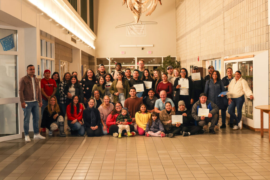 a large group posed with certificates.