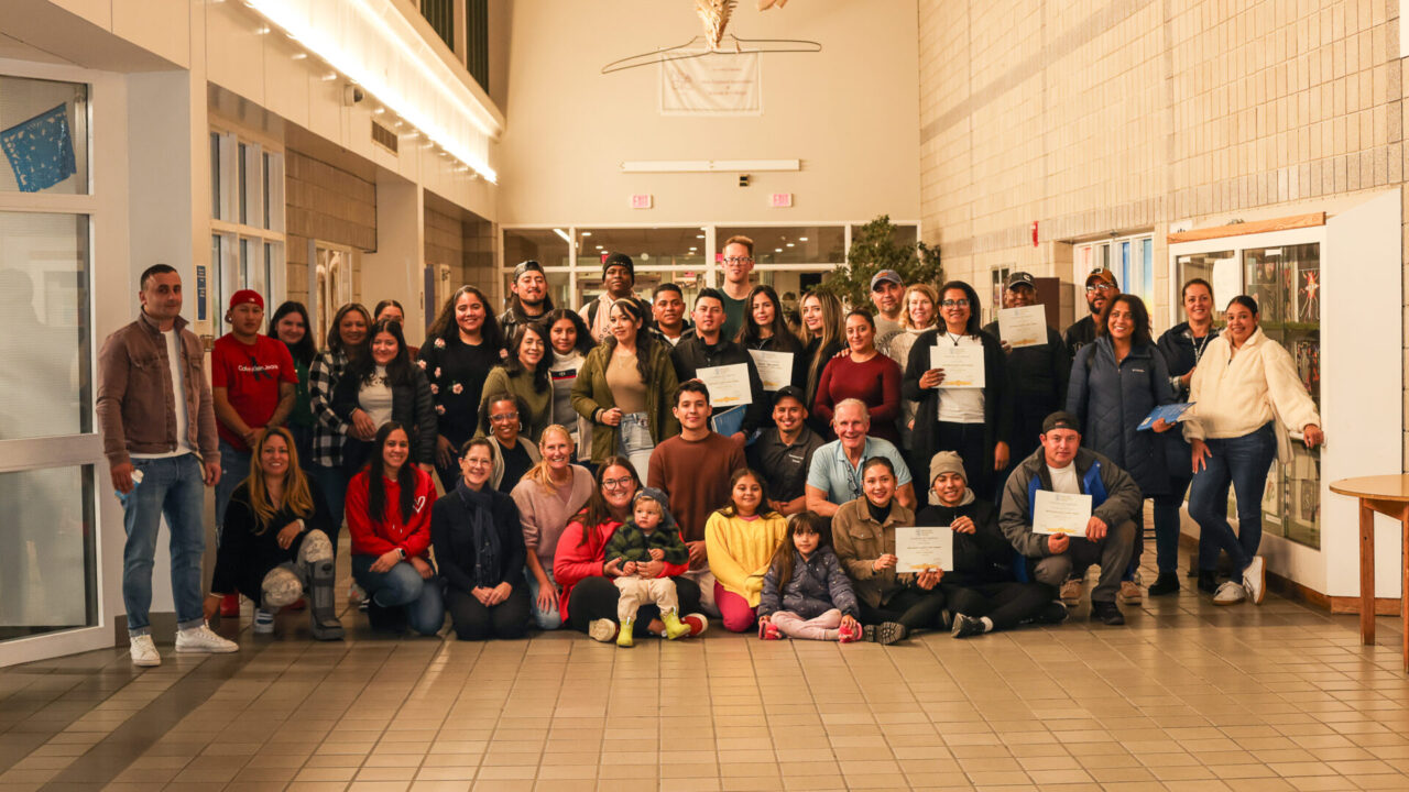 a large group posed with certificates.